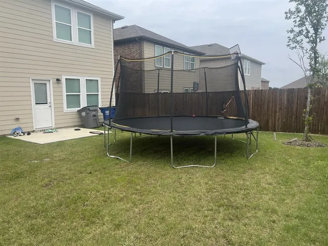 a view of a chairs and table in backyard of the house