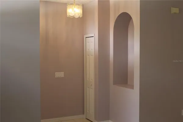 a view of a closet area with chandelier fan