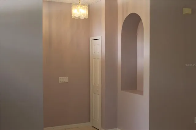 a view of a closet area with chandelier fan