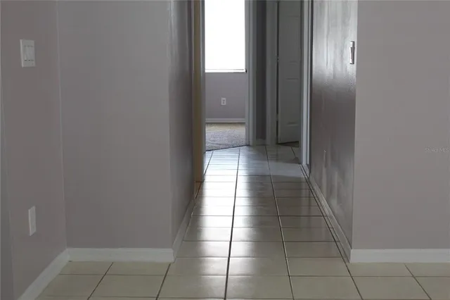 an empty room with a bathroom and a window