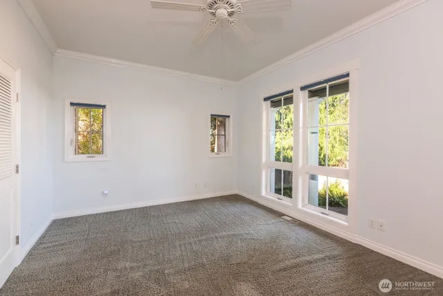 a view of a room with wooden floor and windows