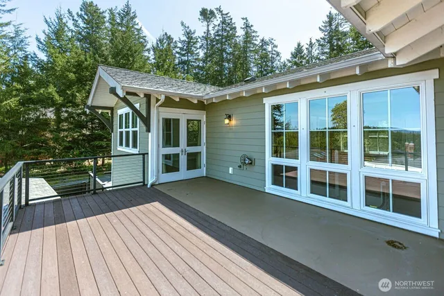 a roof deck with a table and chairs