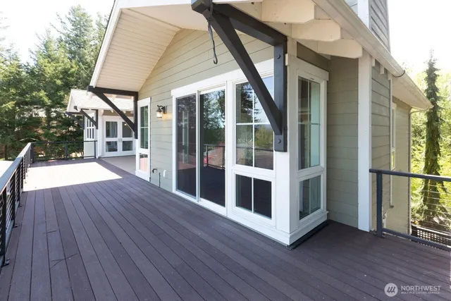 front view of a house with a yard and potted plants