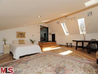 a spacious bedroom with a bed and a table