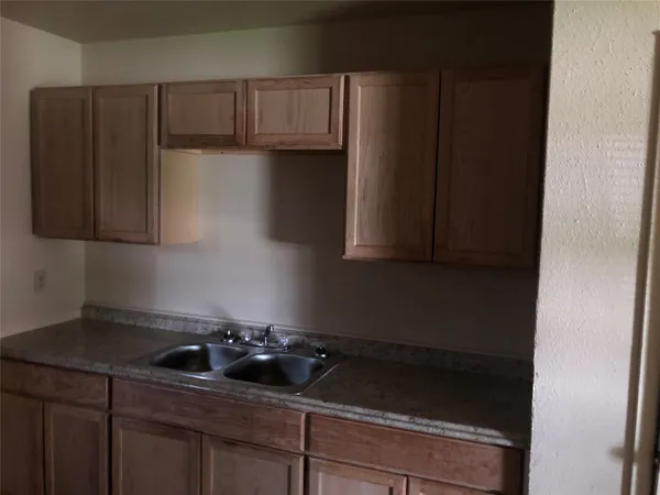 a kitchen with a sink and cabinets