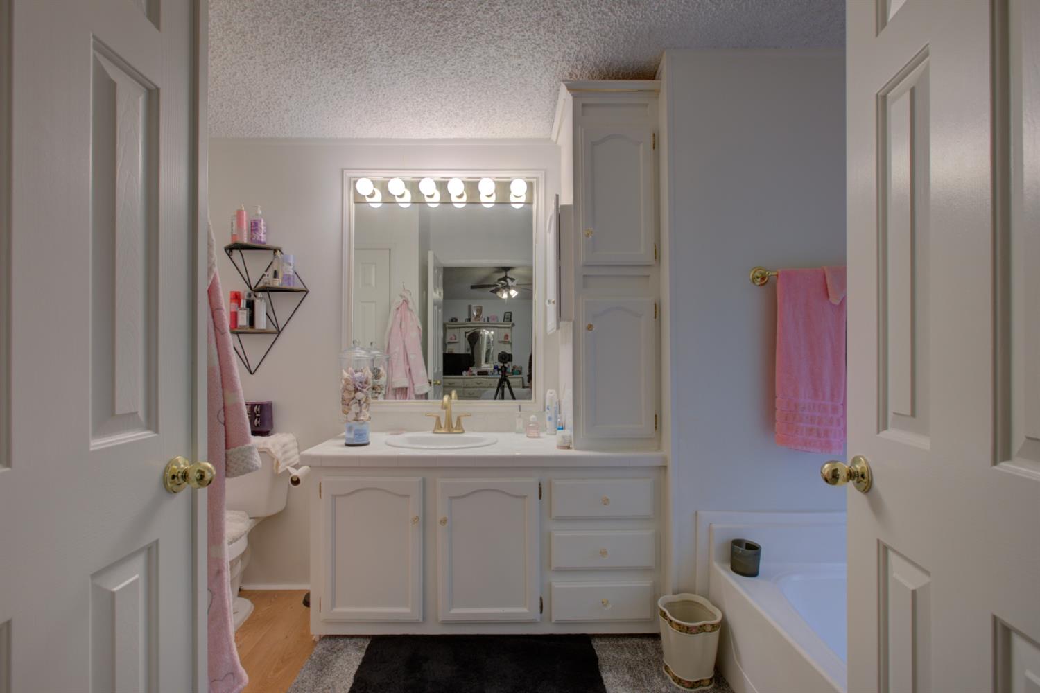 500 North Tully Road, Unit 64 Turlock, CA 95380 - Photo 12 of 38 a bathroom with a sink mirror and vanity