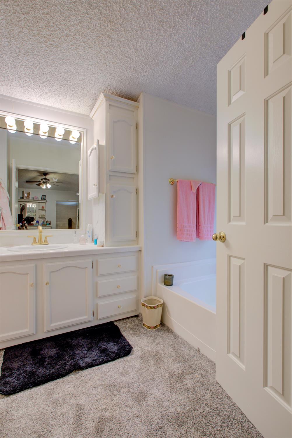 500 North Tully Road, Unit 64 Turlock, CA 95380 - Photo 13 of 38 a bathroom with a sink a vanity and a mirror