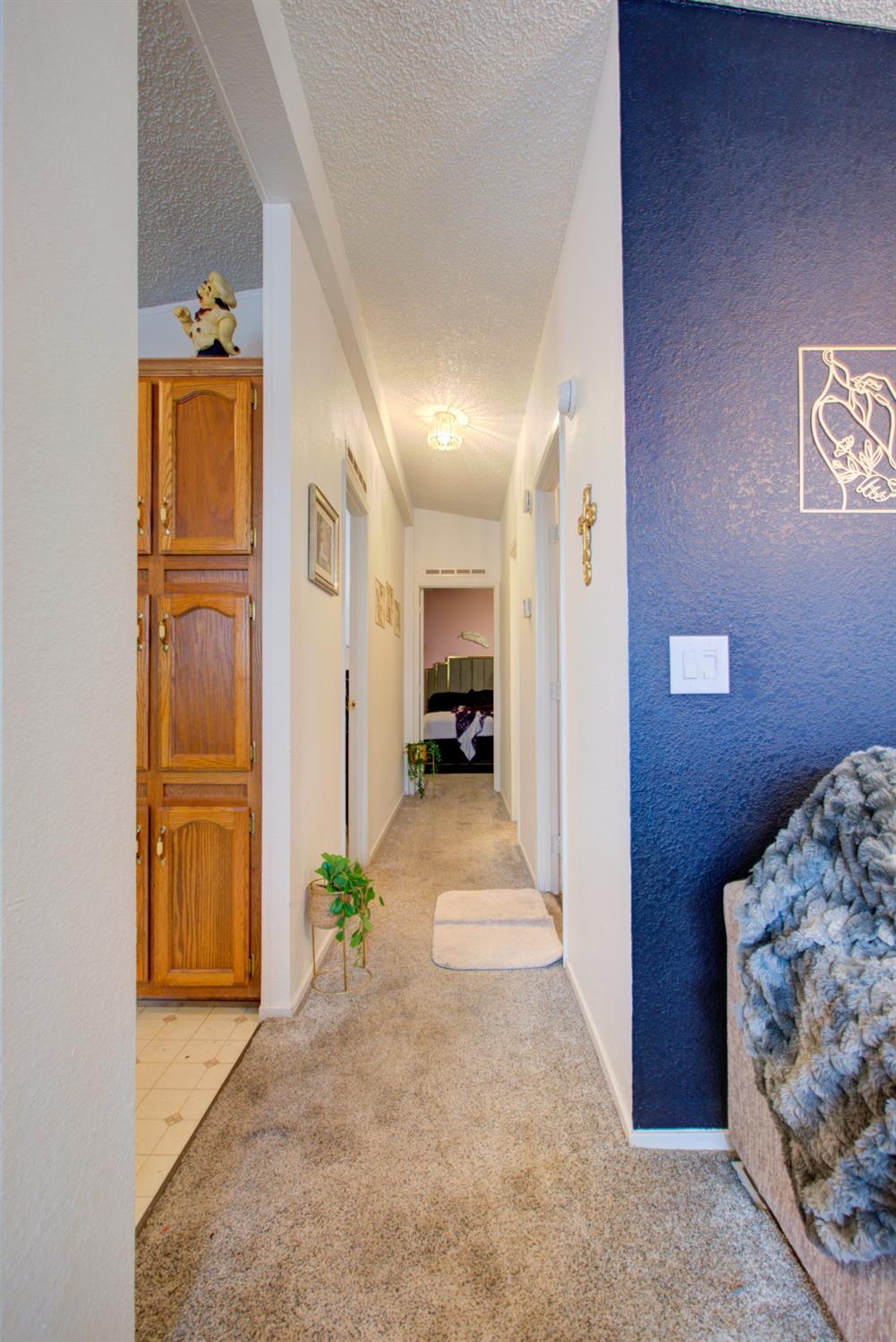 500 North Tully Road, Unit 64 Turlock, CA 95380 - Photo 16 of 38 a hallway with sliding door and bedroom view