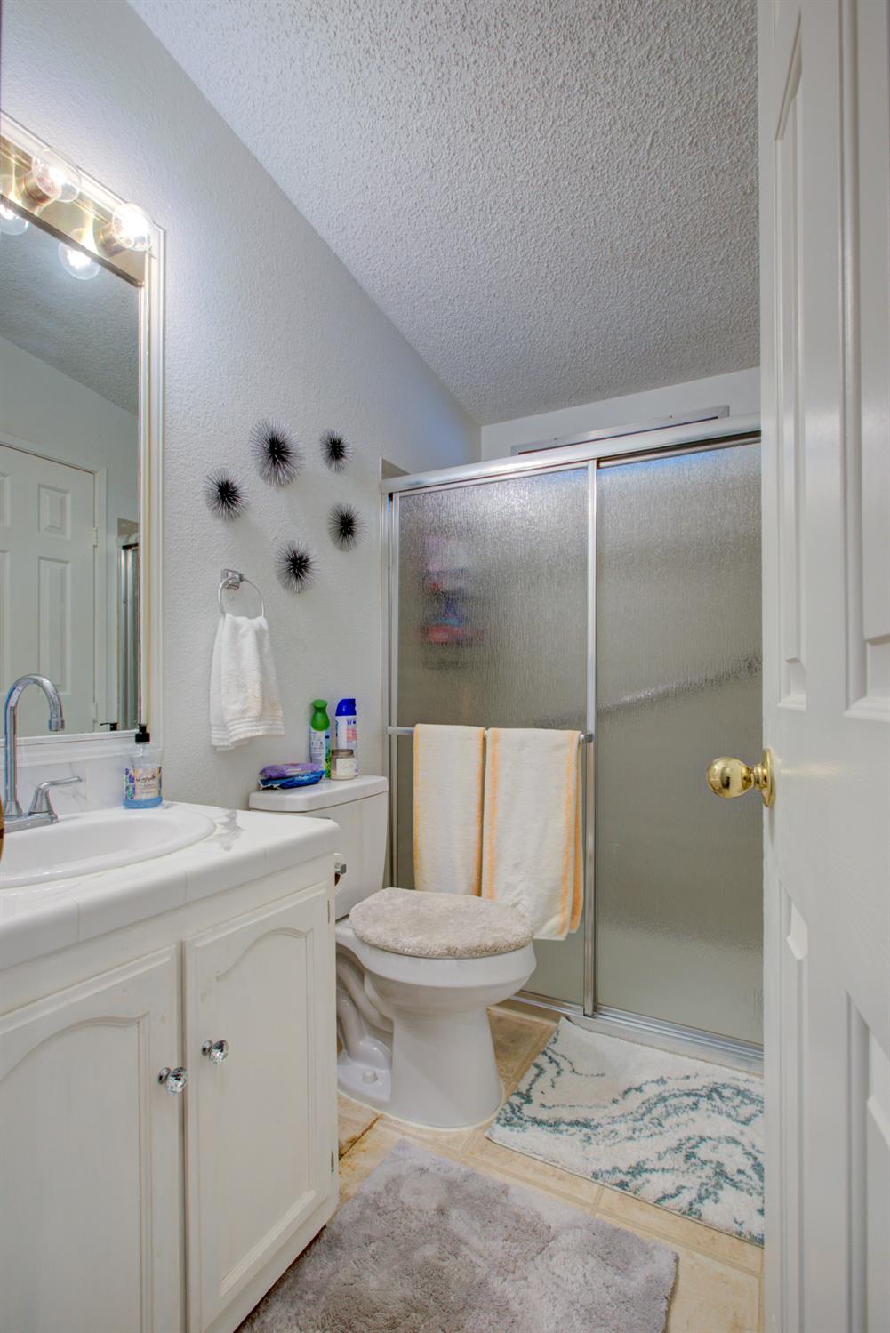 500 North Tully Road, Unit 64 Turlock, CA 95380 - Photo 17 of 38 a bathroom with a sink toilet and shower