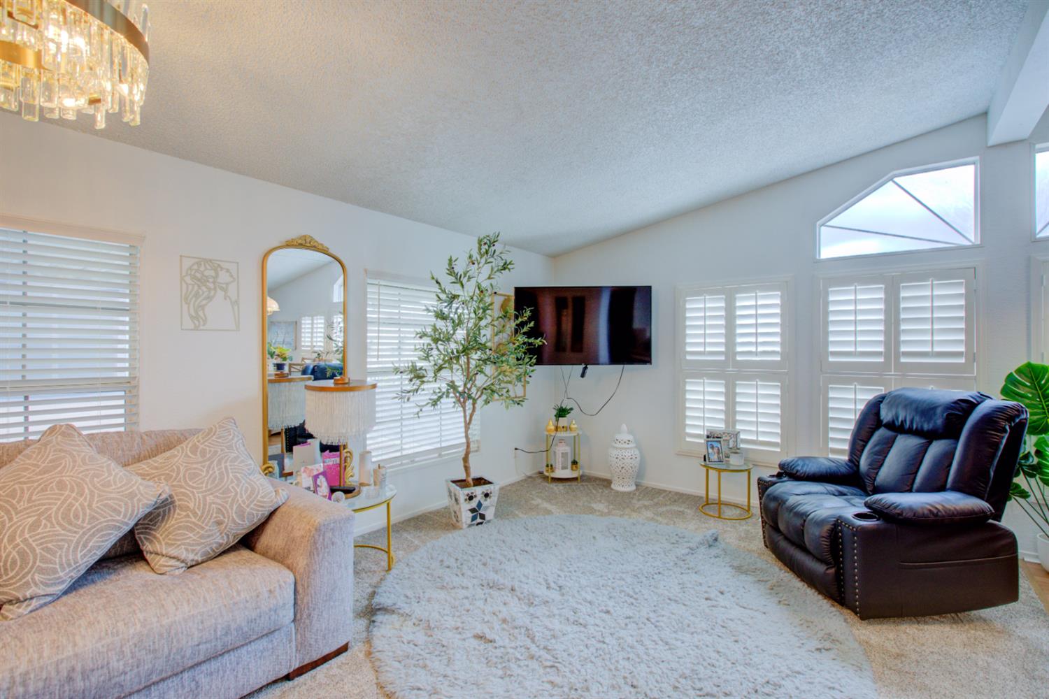 500 North Tully Road, Unit 64 Turlock, CA 95380 - Photo 2 of 38 a living room with furniture and a flat screen tv