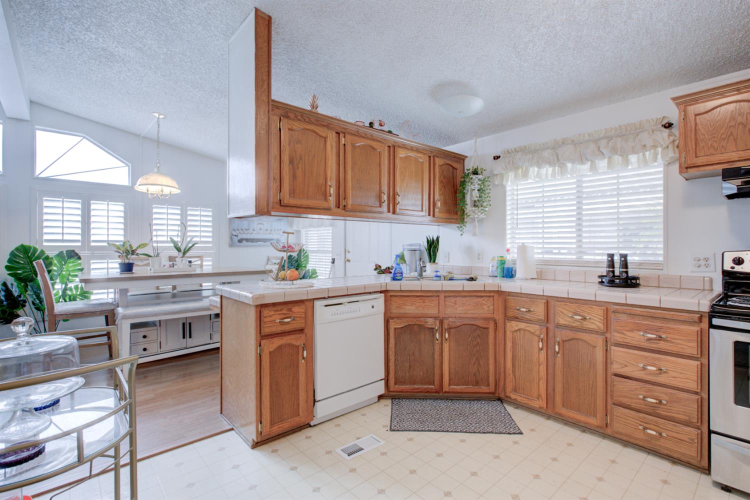 500 North Tully Road, Unit 64 Turlock, CA 95380 - Photo 27 of 38 a kitchen with kitchen island granite countertop appliances cabinets and a sink