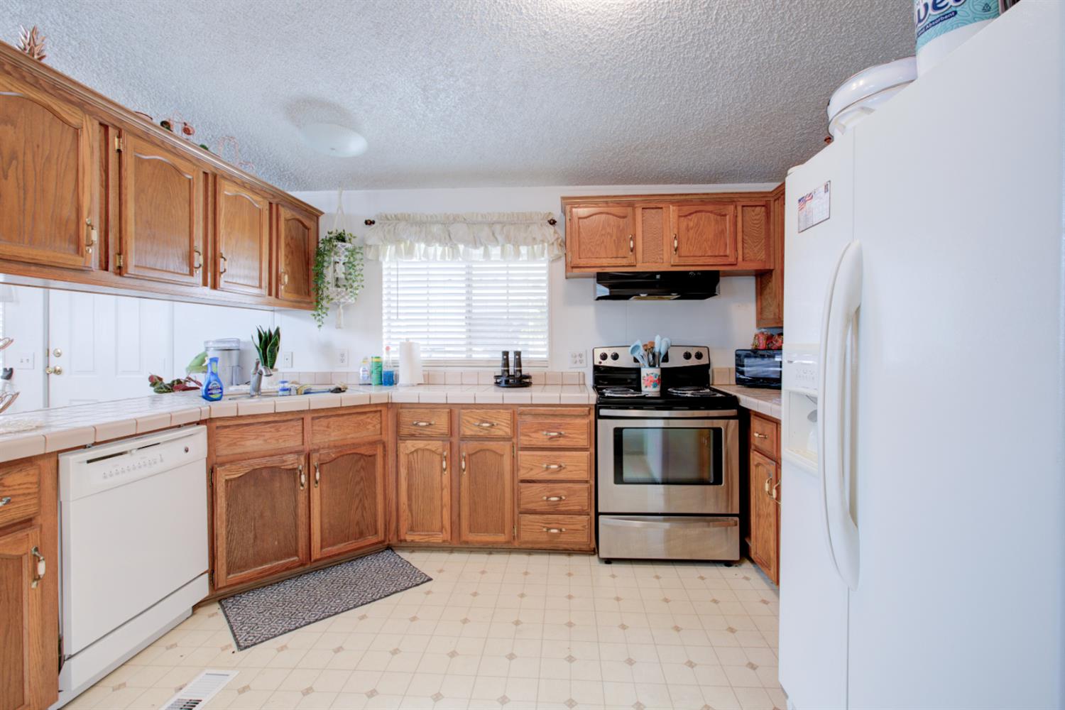 500 North Tully Road, Unit 64 Turlock, CA 95380 - Photo 4 of 38 a kitchen with granite countertop a sink and cabinets
