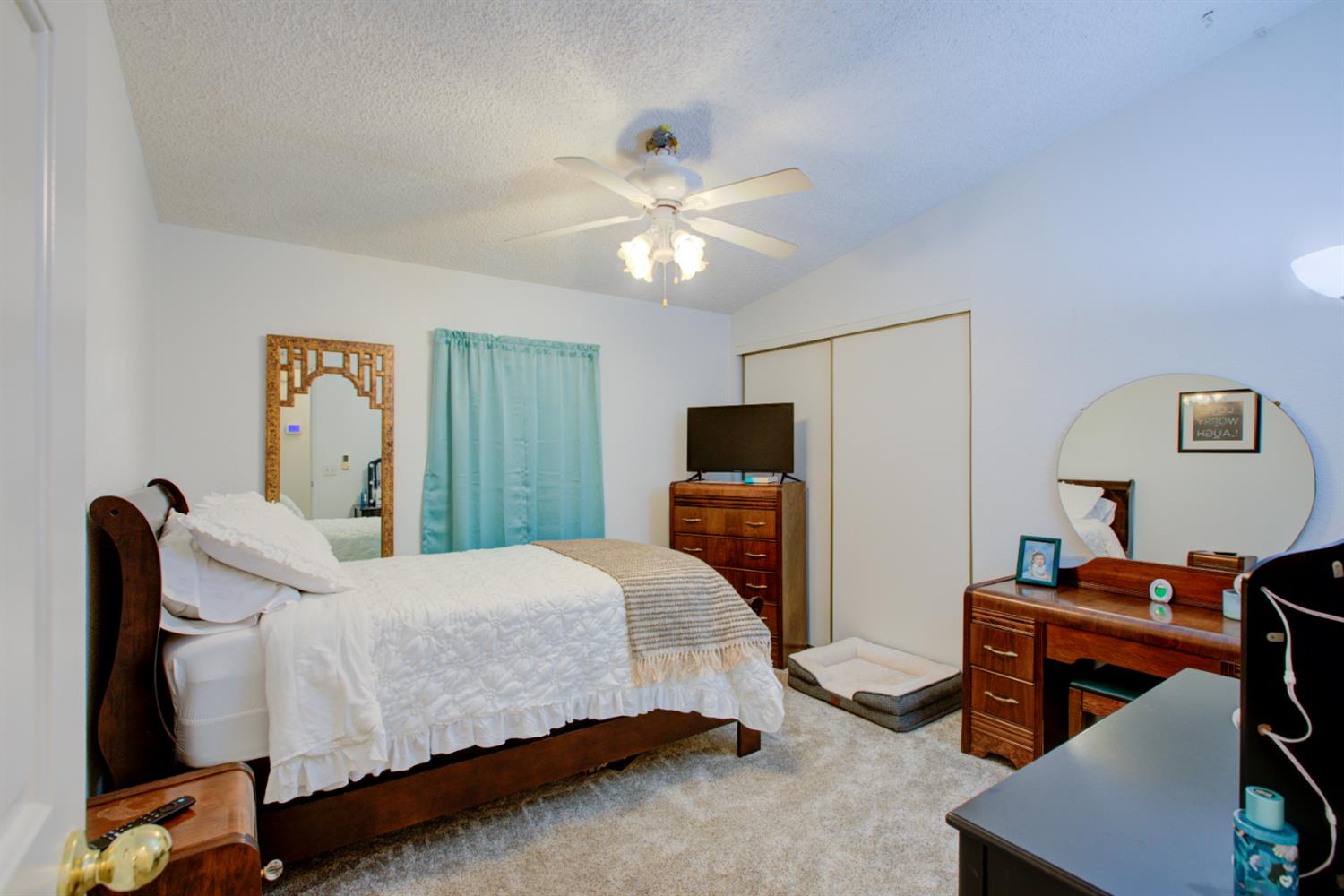 500 North Tully Road, Unit 64 Turlock, CA 95380 - Photo 5 of 38 a bedroom with a bed and a flat screen tv