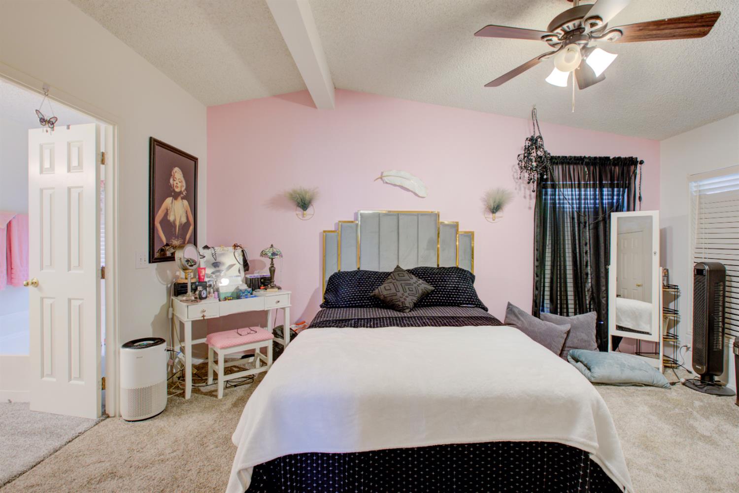 500 North Tully Road, Unit 64 Turlock, CA 95380 - Photo 6 of 38 a bedroom with a bed and a chandelier