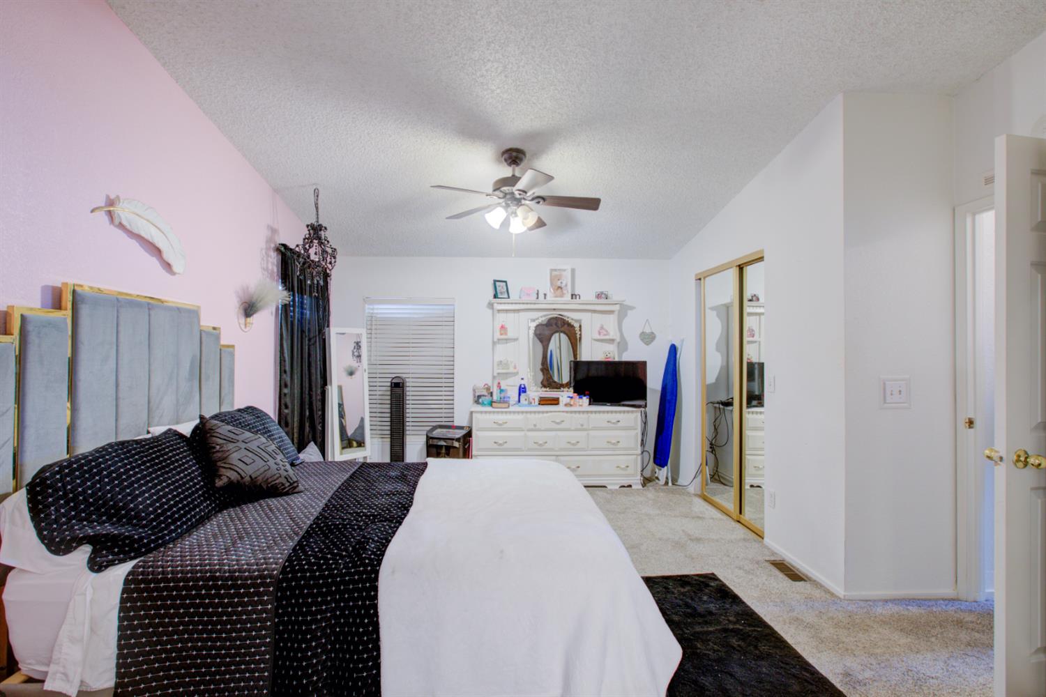 500 North Tully Road, Unit 64 Turlock, CA 95380 - Photo 10 of 38 a bed room with a bed and a chandelier