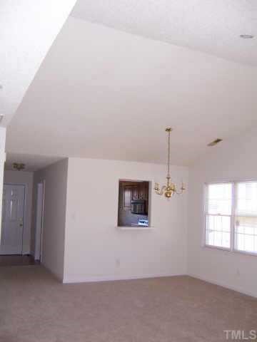6712 Twin Tree Court Raleigh, NC 27613 - Photo 3 of 9 an empty room with windows
