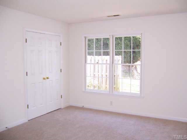 6712 Twin Tree Court Raleigh, NC 27613 - Photo 6 of 9 an empty room with a window