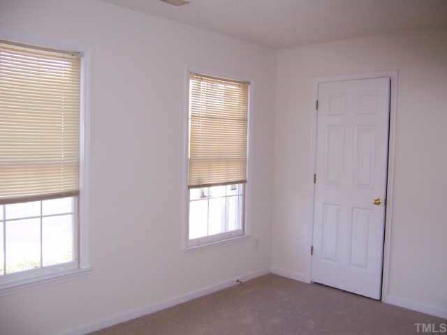 6712 Twin Tree Court Raleigh, NC 27613 - Photo 7 of 9 an empty room with windows