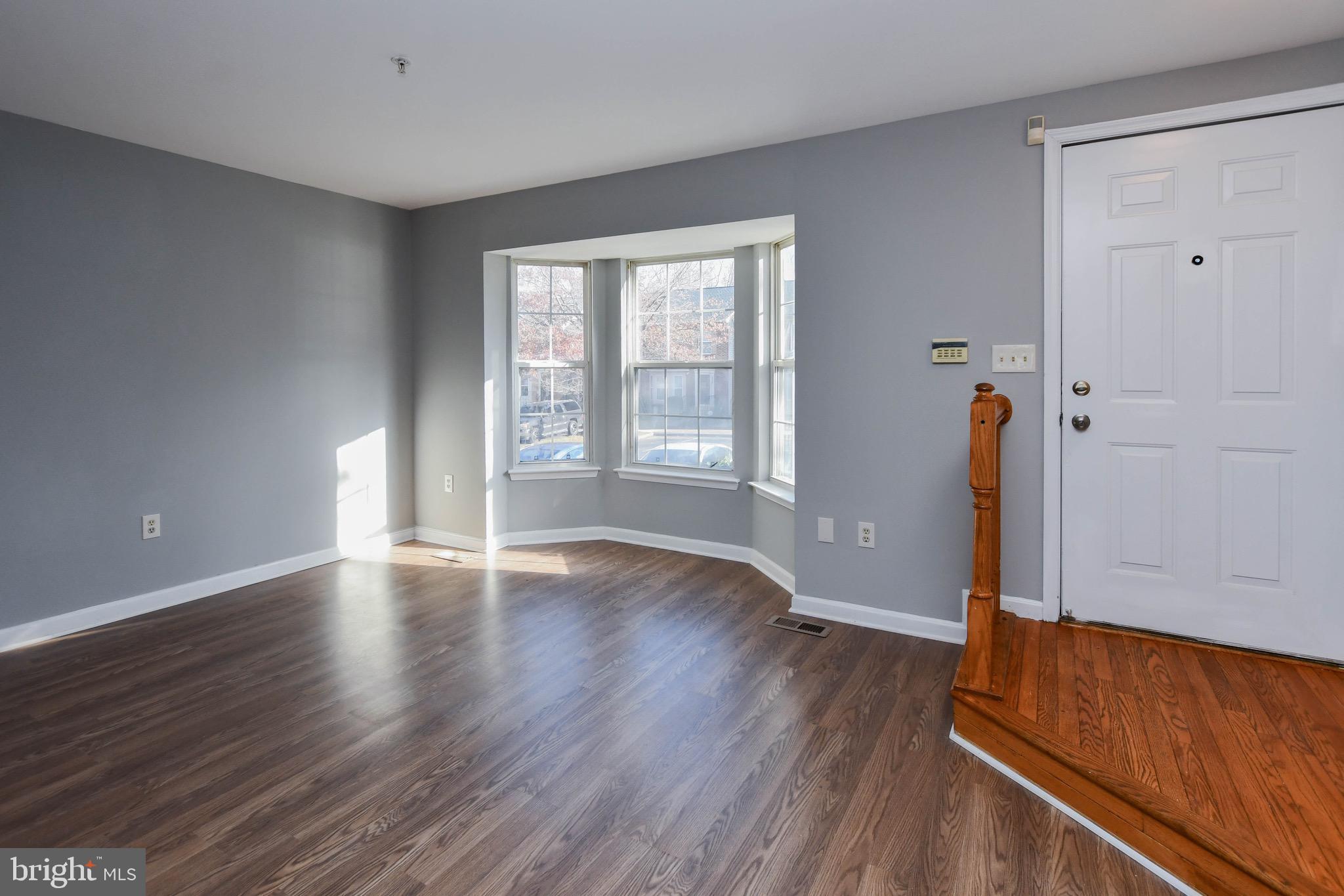 8802 Ritchboro Road District Heights, MD 20747 - Photo 8 of 66 an empty room with wooden floor and window
