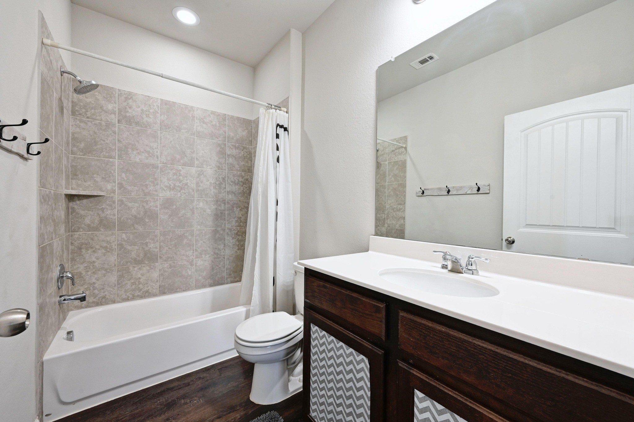 328 Triumph Road Buda, TX 78610 - Photo 14 of 18 Full bathroom featuring shower / bath combo, vanity, toilet, and wood finished floors