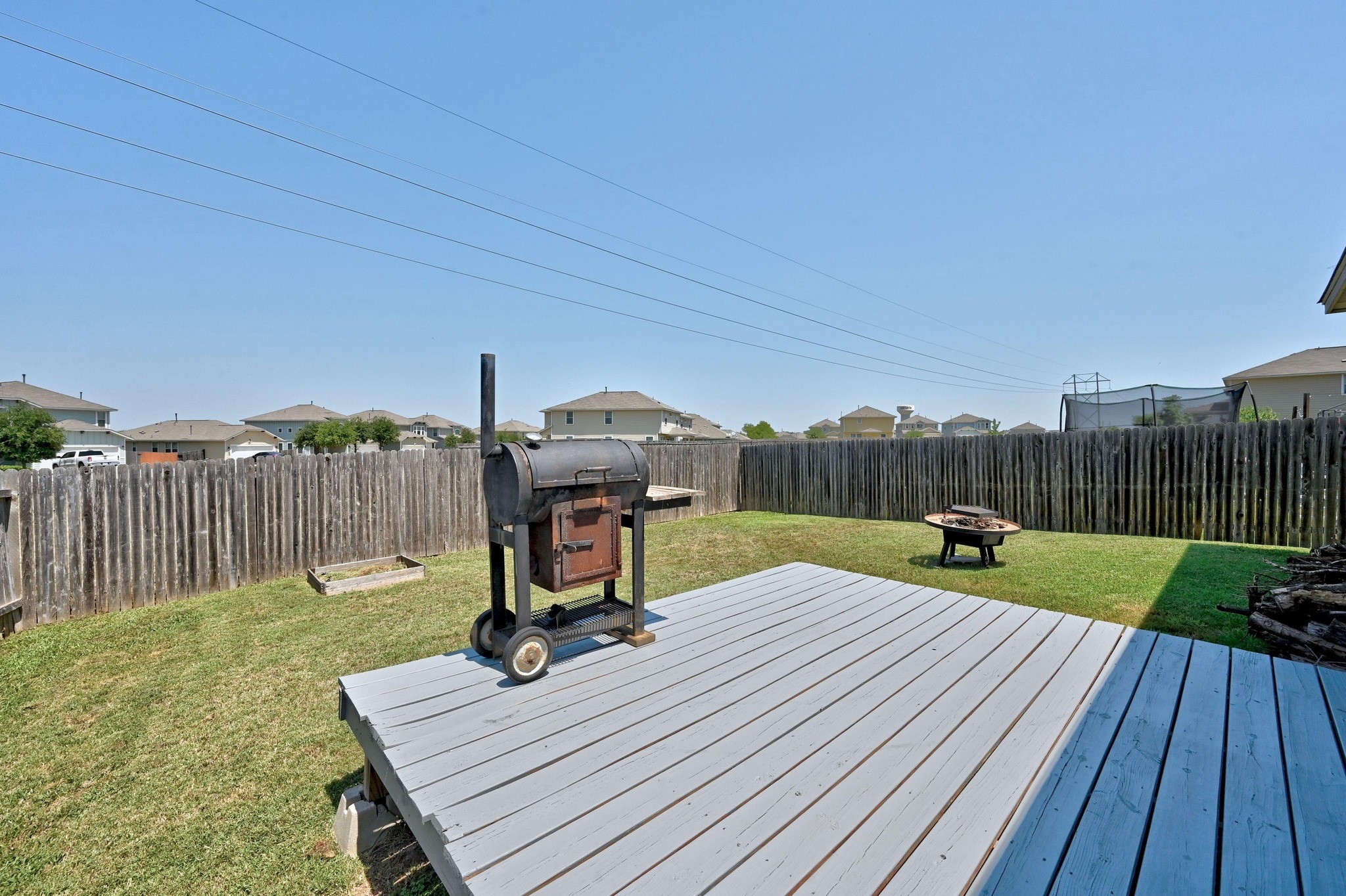328 Triumph Road Buda, TX 78610 - Photo 16 of 18 Wooden deck featuring a fire pit and a residential view