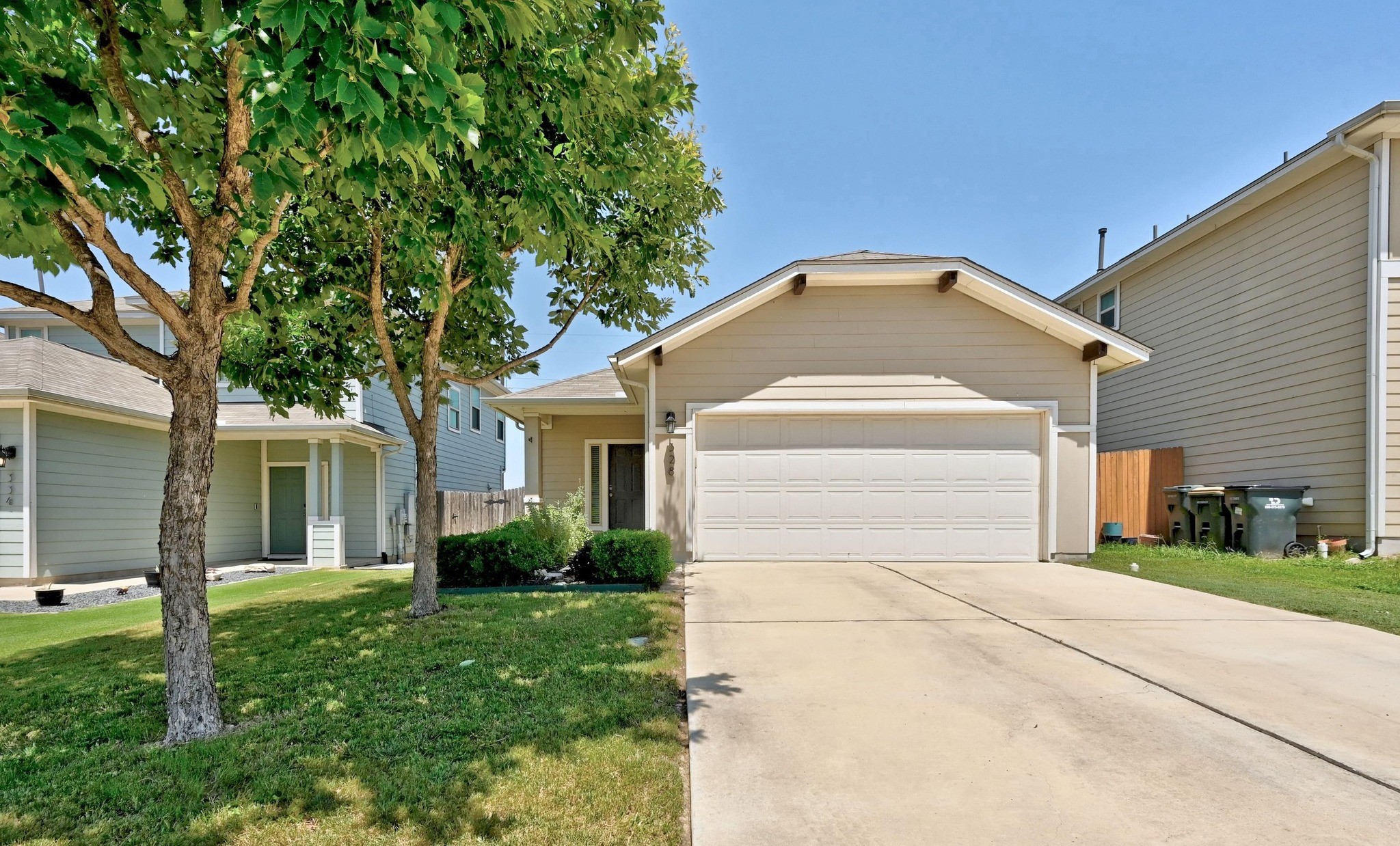 328 Triumph Road Buda, TX 78610 - Photo 4 of 18 View of front of house featuring concrete driveway and an attached garage