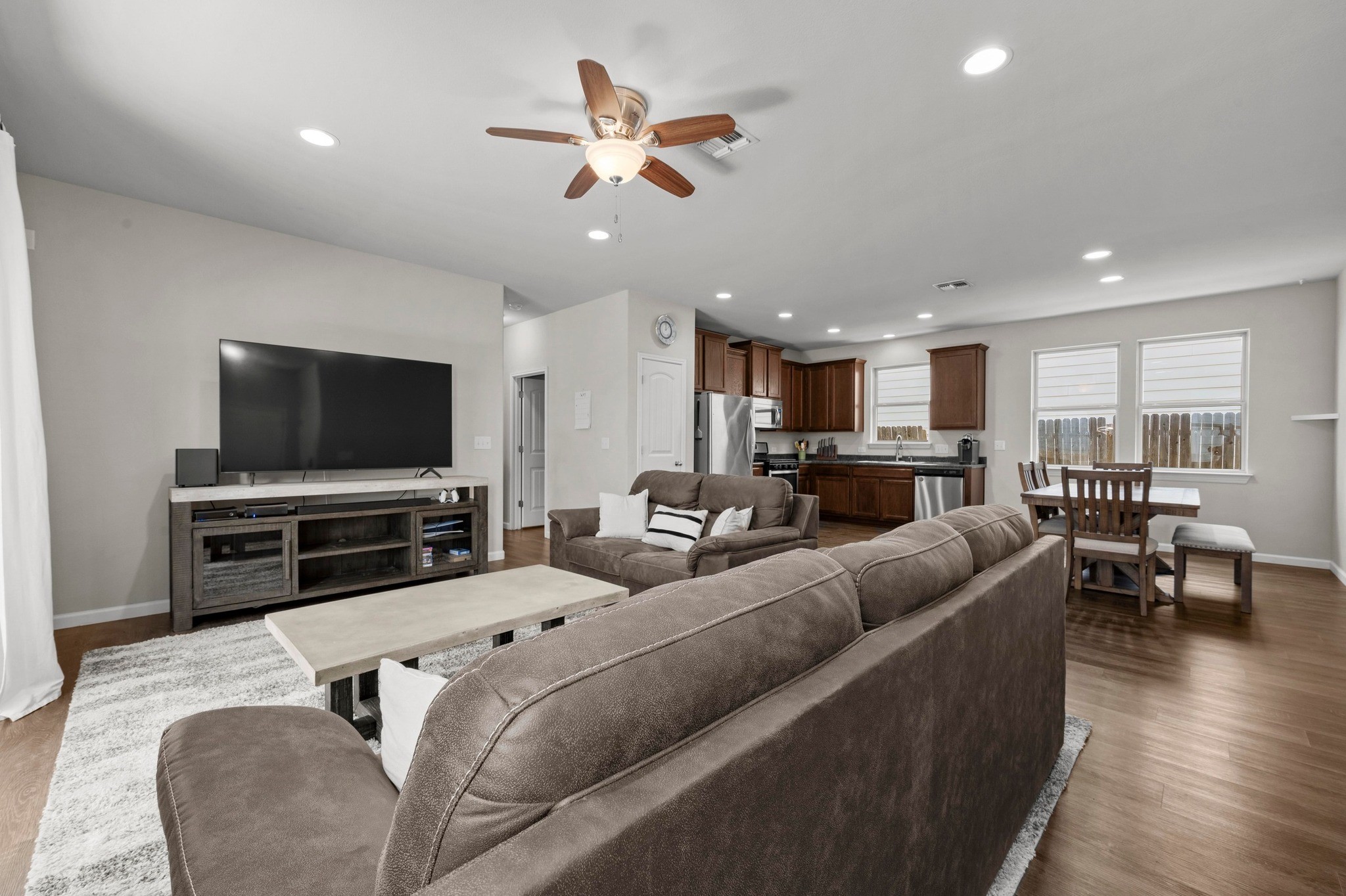 328 Triumph Road Buda, TX 78610 - Photo 6 of 18 Living room with ceiling fan, baseboards, dark wood-style flooring, and recessed lighting