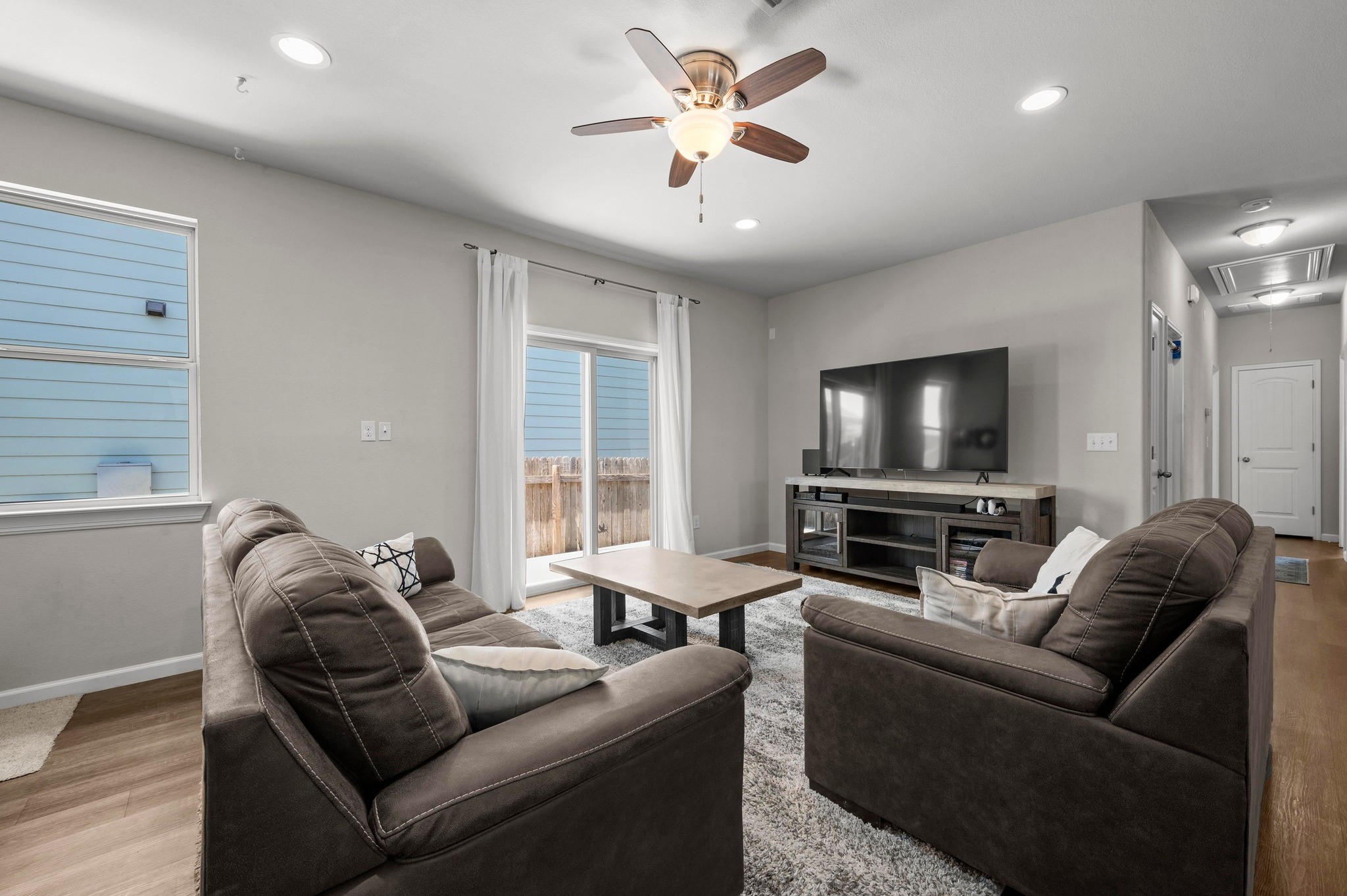 328 Triumph Road Buda, TX 78610 - Photo 7 of 18 Living room with attic access, ceiling fan, wood finished floors, baseboards, and recessed lighting