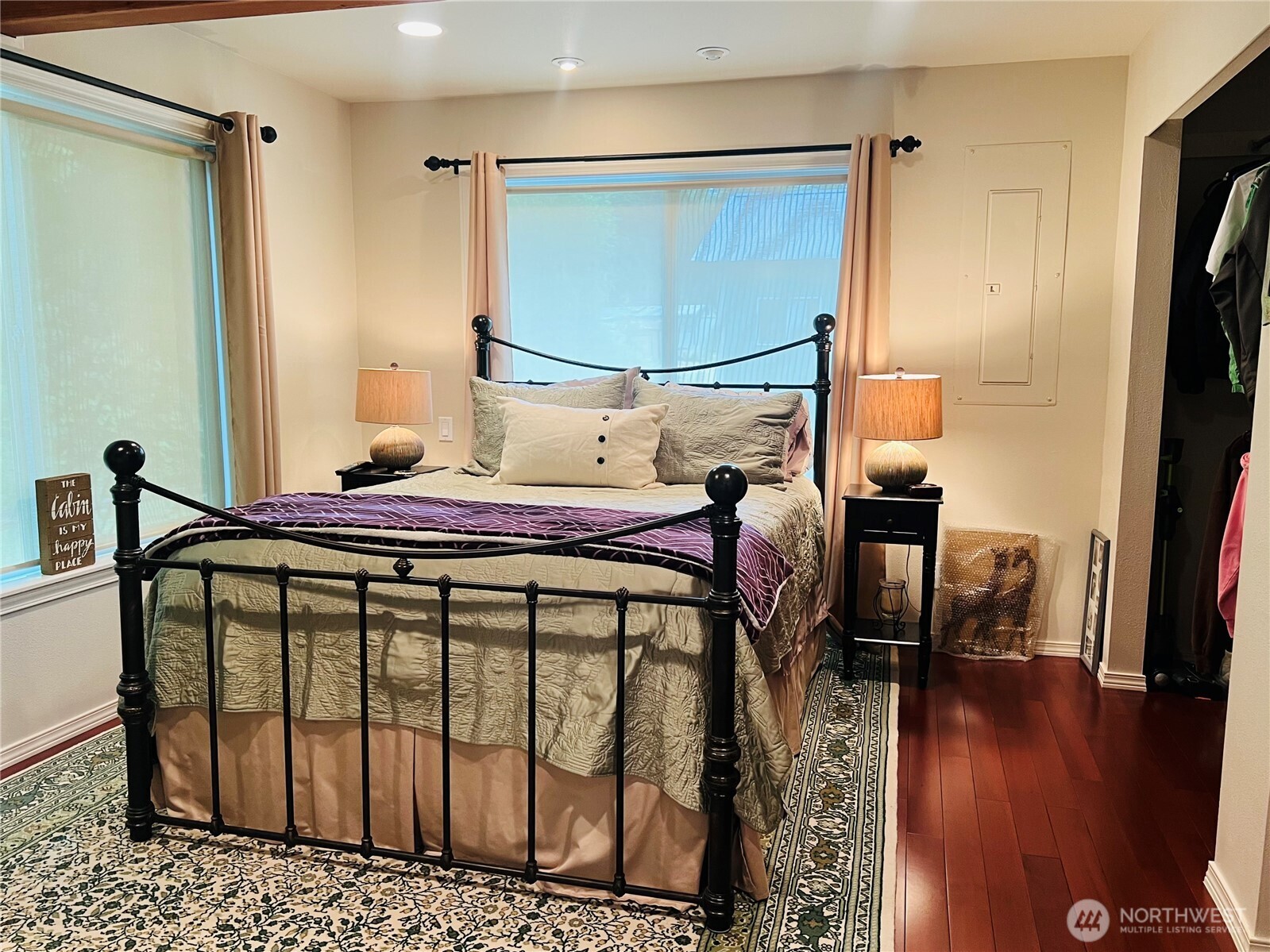 601 Mountain Trail Road Brinnon, WA 98320 - Photo 15 of 30 a bedroom with a bed a mirror and wooden floor