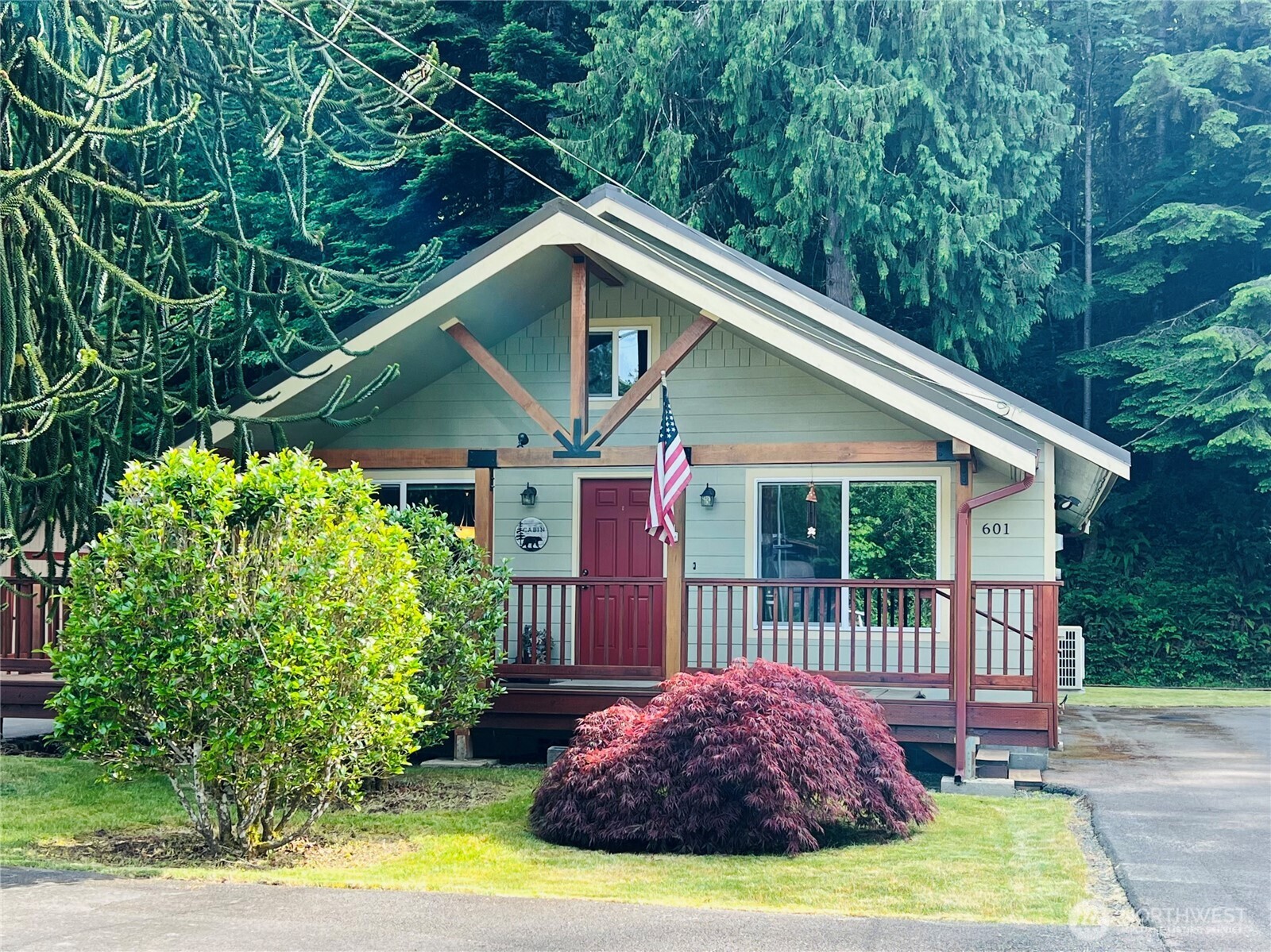 601 Mountain Trail Road Brinnon, WA 98320 - Photo 2 of 30 a view of a house with porch and garden