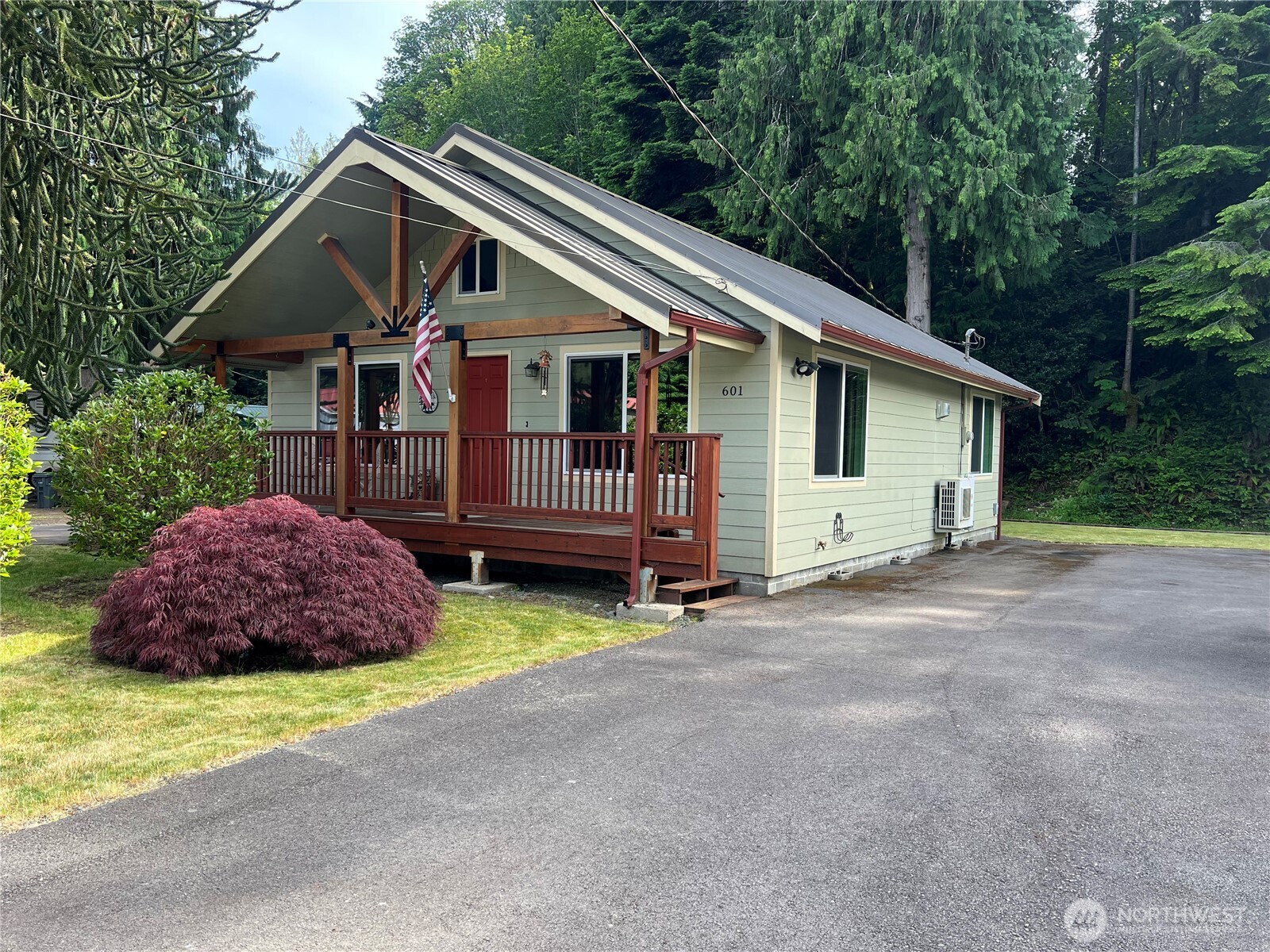 601 Mountain Trail Road Brinnon, WA 98320 - Photo 3 of 30 a front view of a house with a garden