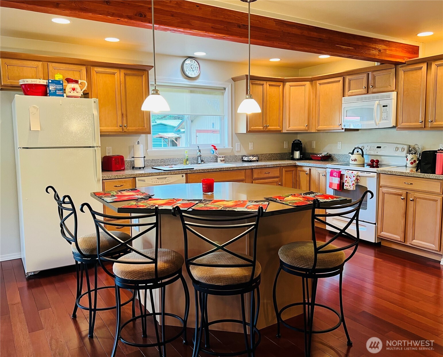 601 Mountain Trail Road Brinnon, WA 98320 - Photo 7 of 30 a kitchen with a dining table chairs and a refrigerator