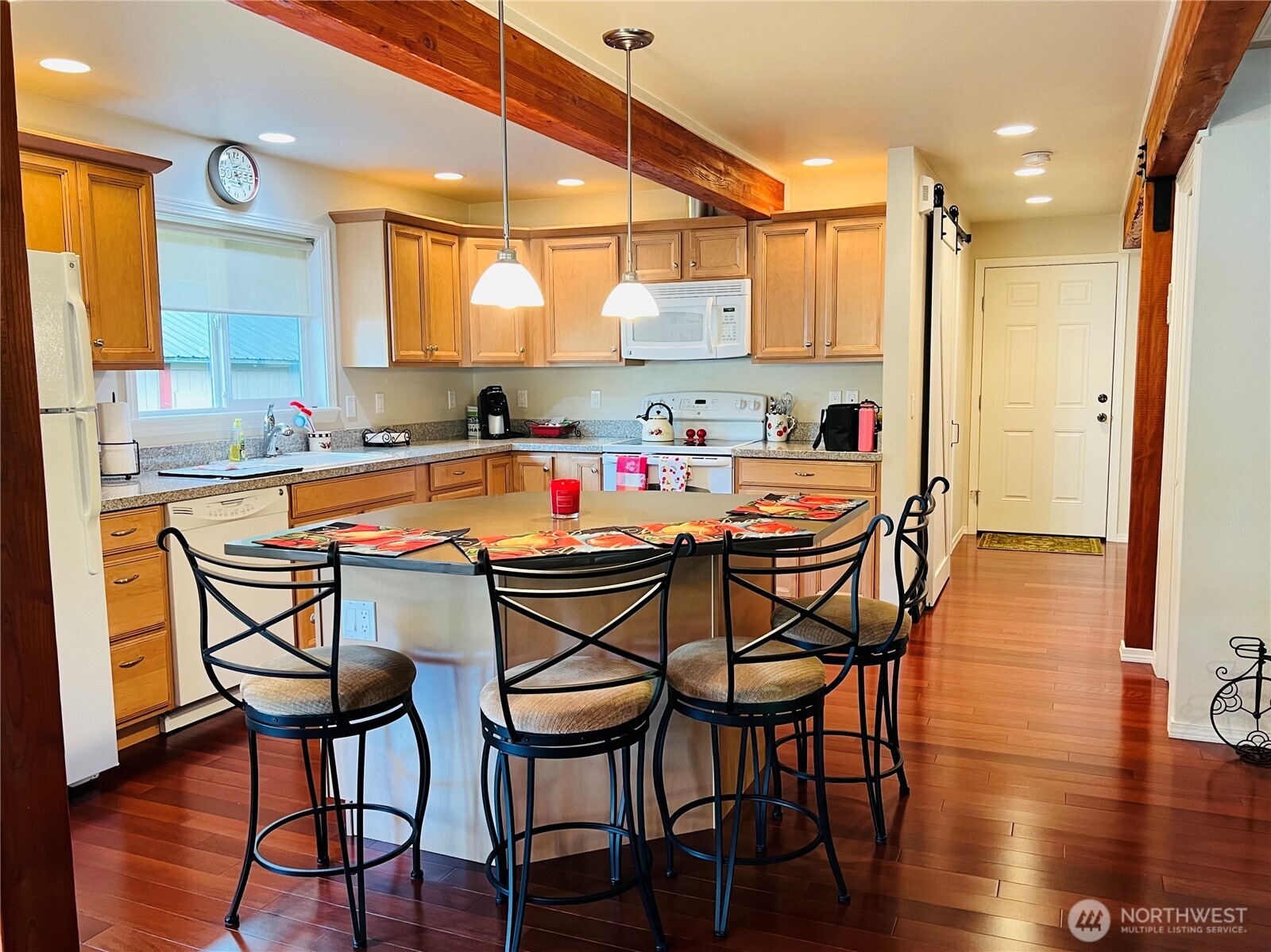 601 Mountain Trail Road Brinnon, WA 98320 - Photo 8 of 30 a dining area with stainless steel appliances a table and chairs with wooden floor