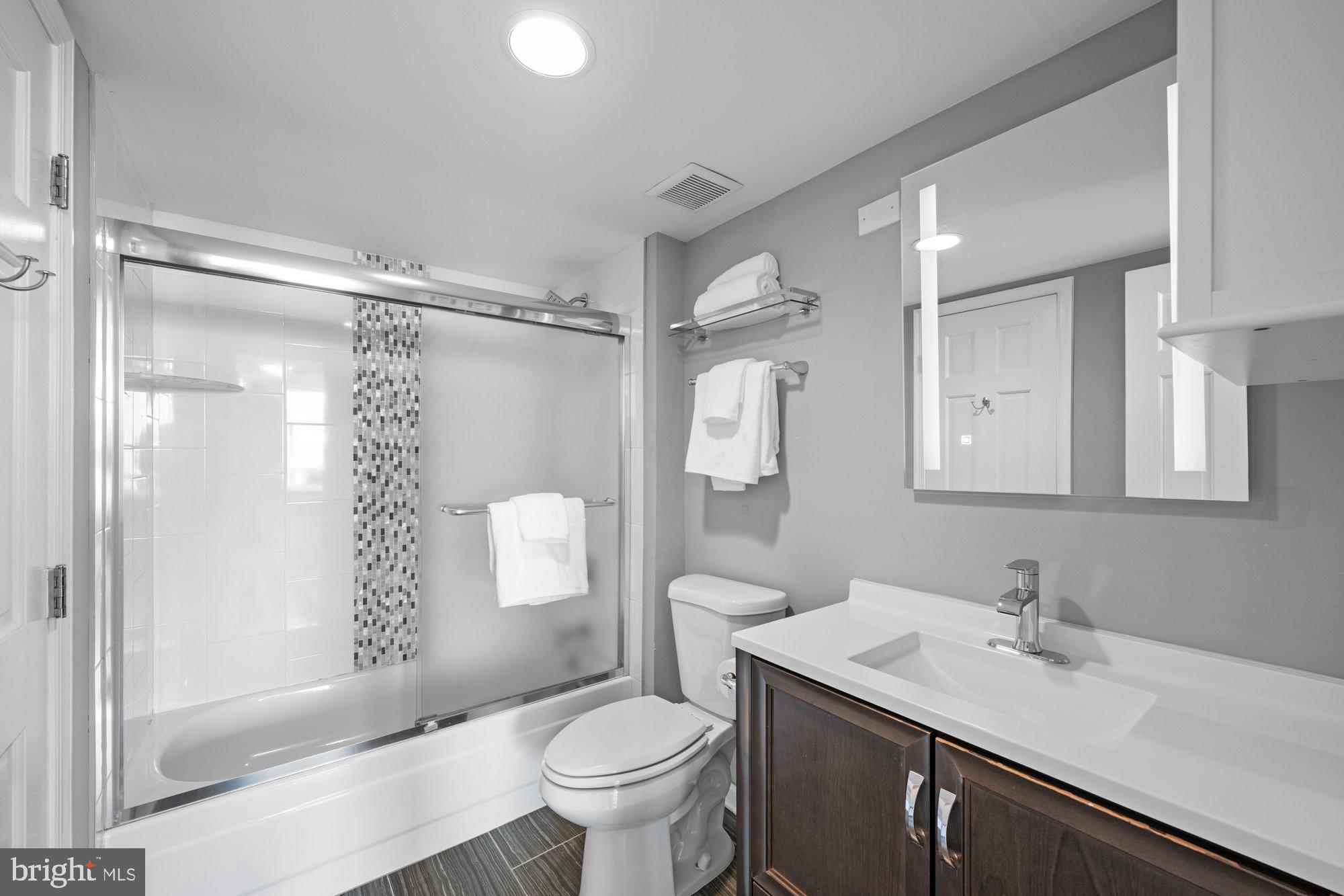701 Pennsylvania Avenue Northwest, Unit PH2 Washington, DC 20004 - Photo 14 of 19 a bathroom with a sink toilet double vanity and shower