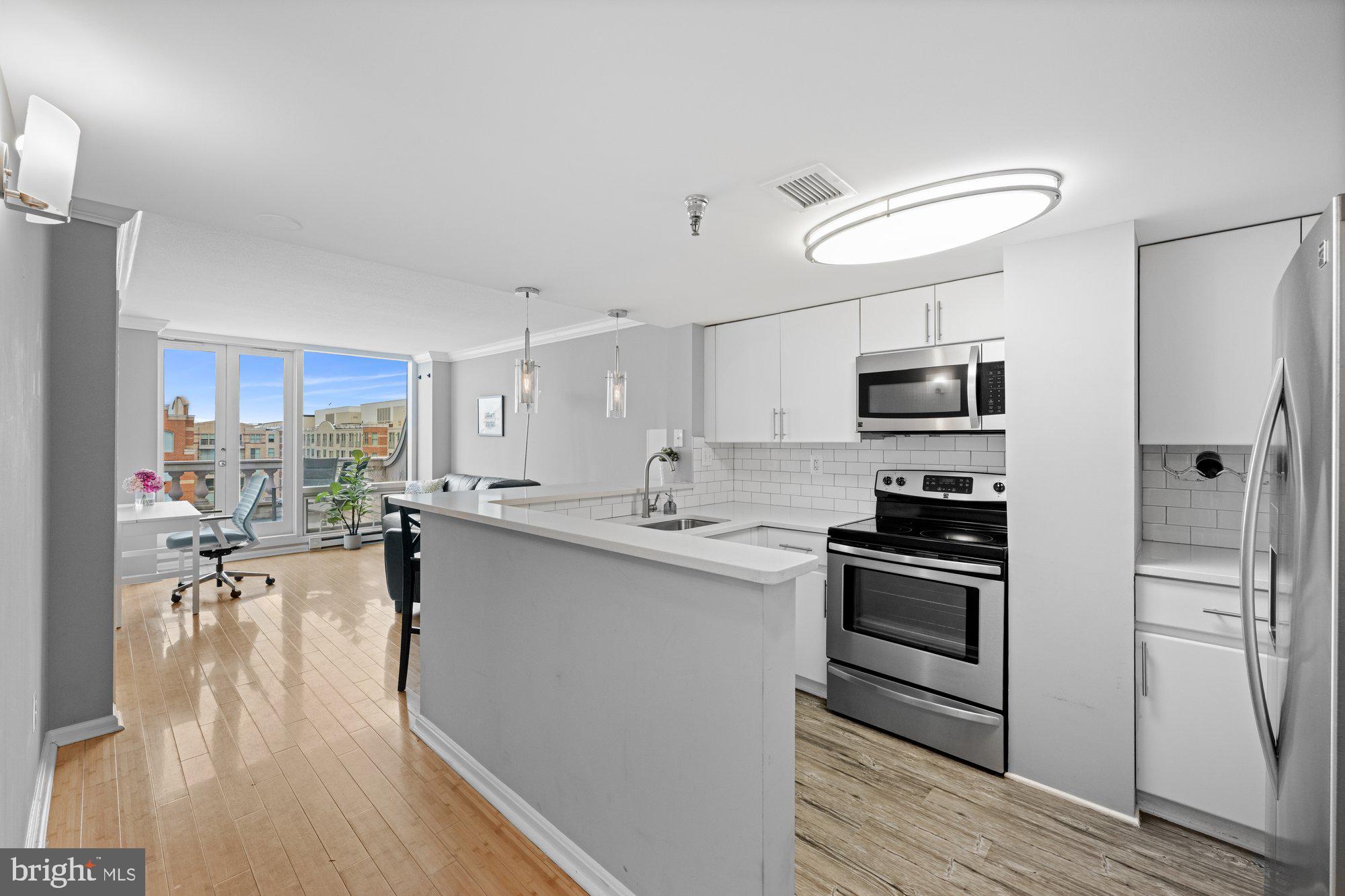 701 Pennsylvania Avenue Northwest, Unit PH2 Washington, DC 20004 - Photo 2 of 19 a kitchen with stainless steel appliances a stove refrigerator sink and microwave