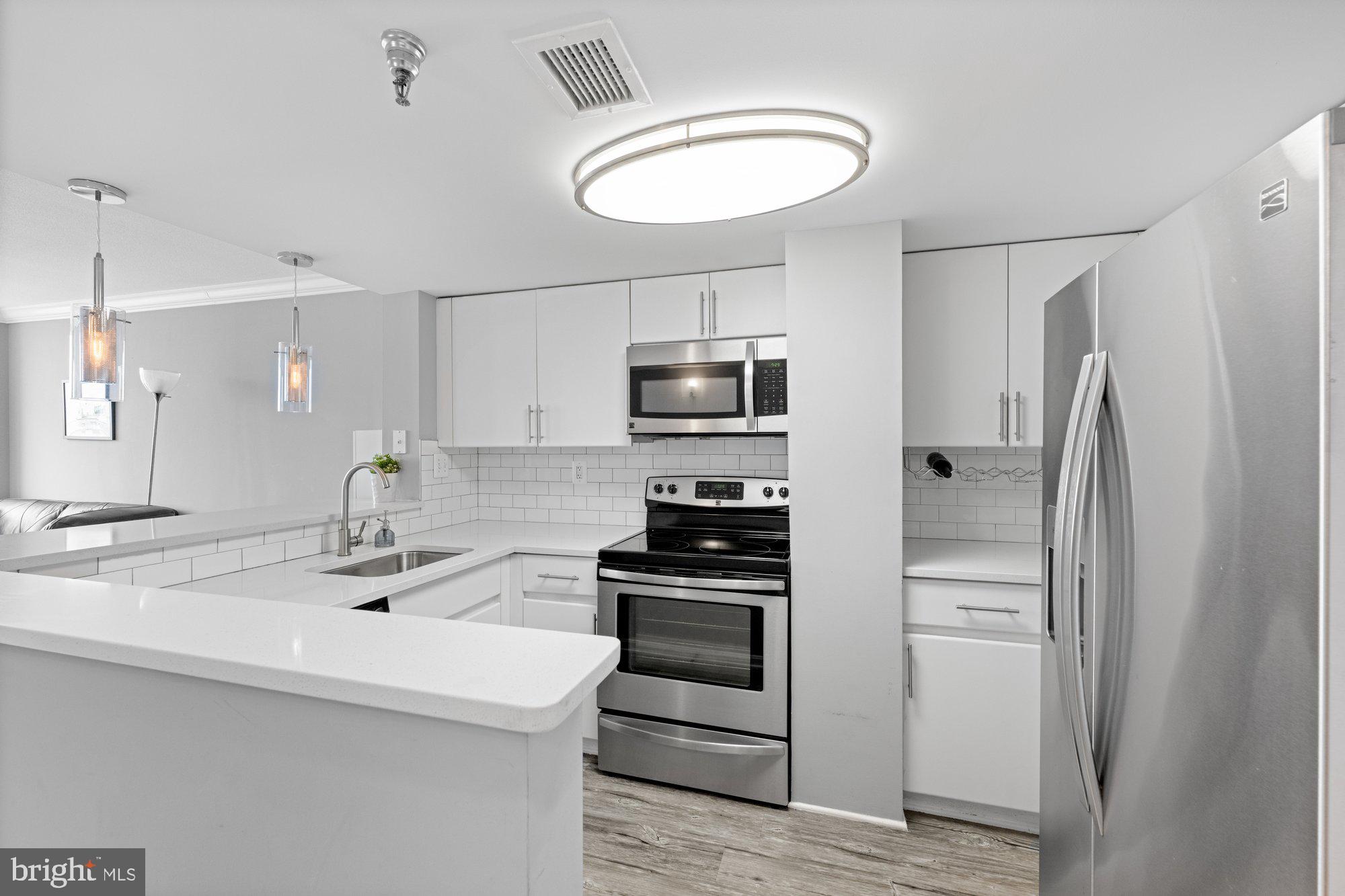701 Pennsylvania Avenue Northwest, Unit PH2 Washington, DC 20004 - Photo 3 of 19 a kitchen with a refrigerator an oven and a sink