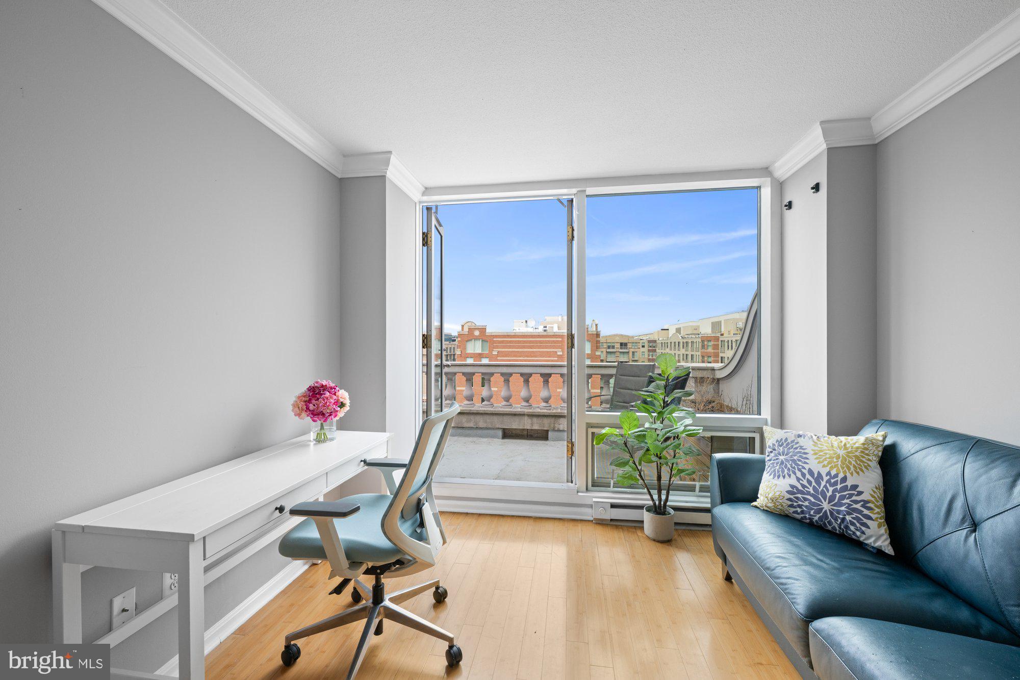 701 Pennsylvania Avenue Northwest, Unit PH2 Washington, DC 20004 - Photo 6 of 19 a living room with furniture and a large window