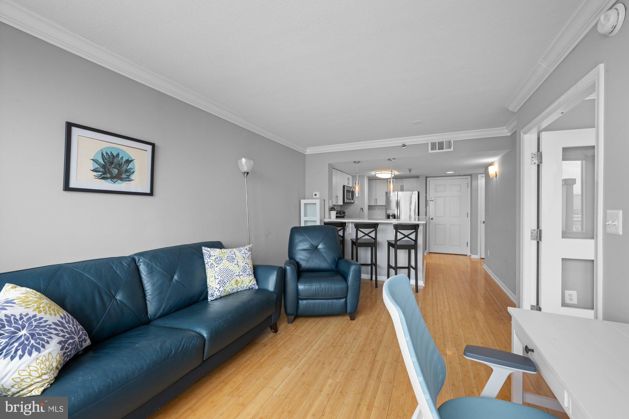 701 Pennsylvania Avenue Northwest, Unit PH2 Washington, DC 20004 - Photo 8 of 19 a living room with furniture and kitchen view