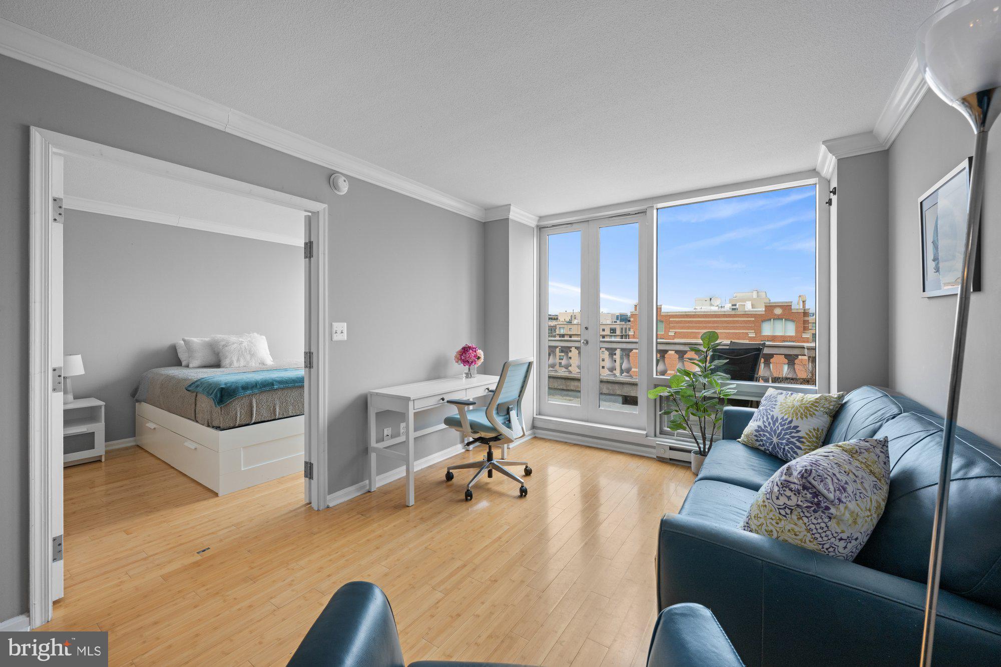 701 Pennsylvania Avenue Northwest, Unit PH2 Washington, DC 20004 - Photo 9 of 19 a living room with furniture and a large window