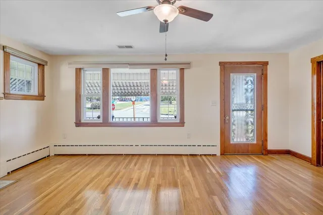 an empty room with windows and entrance