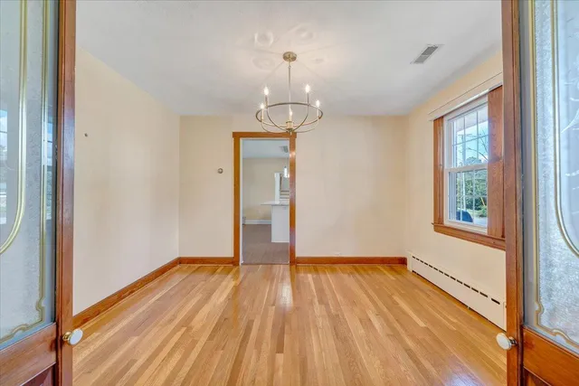 wooden floor in an empty room with a window