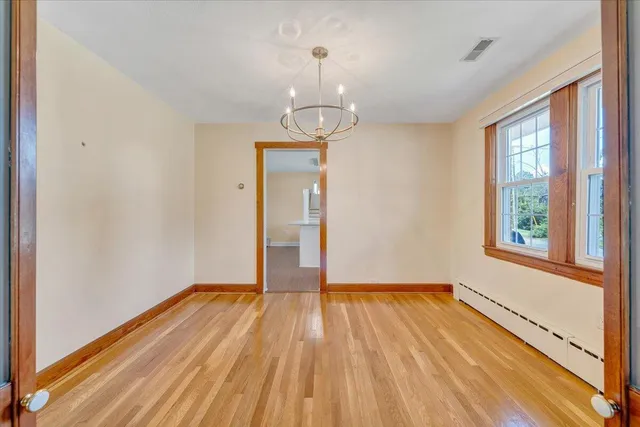 a spacious bathroom with a double vanity sink a mirror and a bathtub