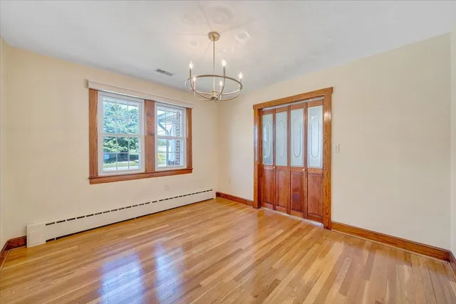 wooden floor in an empty room with a window