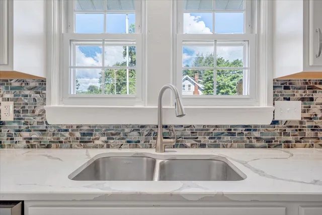 a kitchen with white cabinets and white appliances