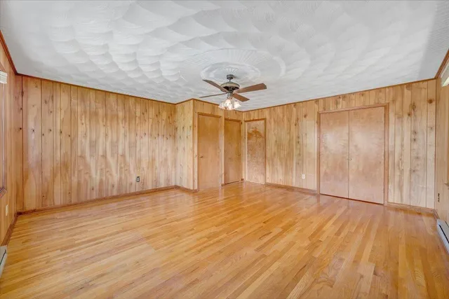a view of a house with a big yard potted plants and large tree