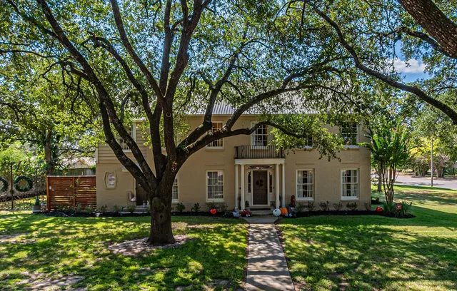 a front view of a house with garden