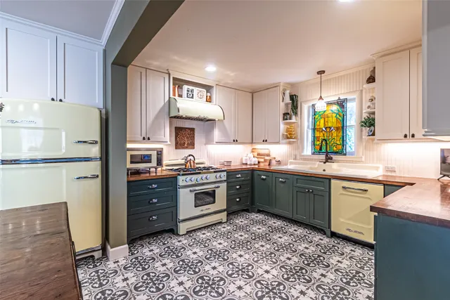 a kitchen with a sink cabinets and window