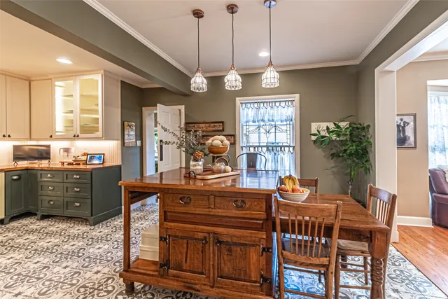 a view of a kitchen with a stove top oven a sink and potted plants