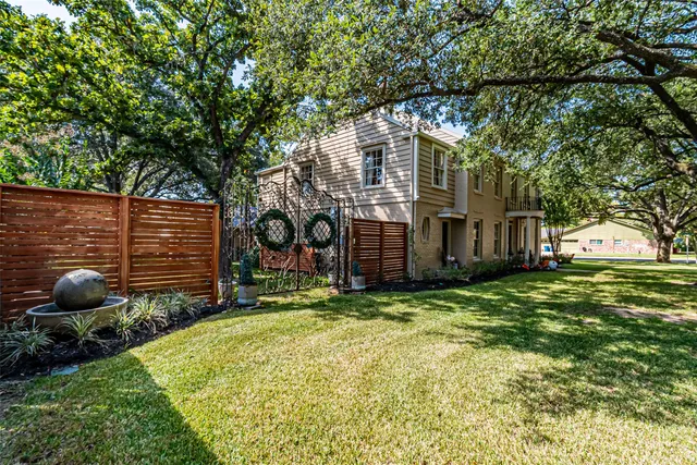 a backyard of a house with barbeque oven and a fountain