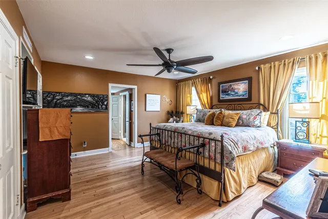 a en suite bathroom with a granite countertop sink and a mirror